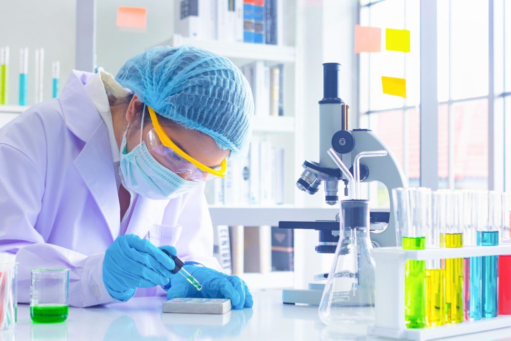 Body past scientist working in laboratory.She is trying and research with red and blue test tube. Experiment , chemical Photo concept develop and medicine.