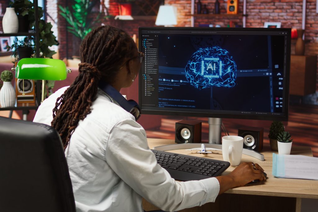 Happy programmer celebrating after successfully implementing code using artificial intelligence computing. Cheerful employee excited after finishing work on AI deep neural networks on PC.