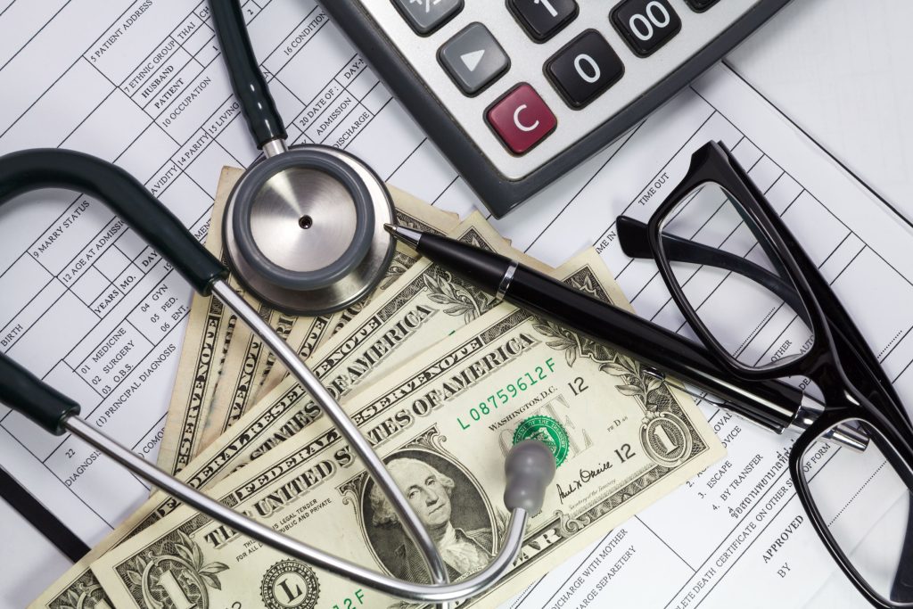 Health care costs. Stethoscope and money symbol for health care costs or medical insurance.